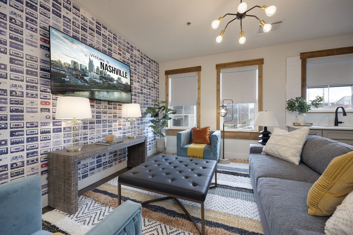 The living room at The Rambler, a wall of Nashville photographs behind the sofa