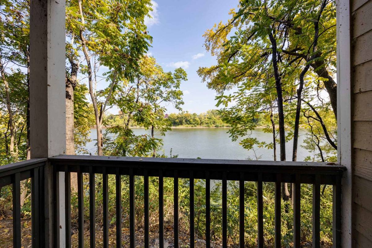 Enjoy serene lake views from your private balcony surrounded by vibrant nature.