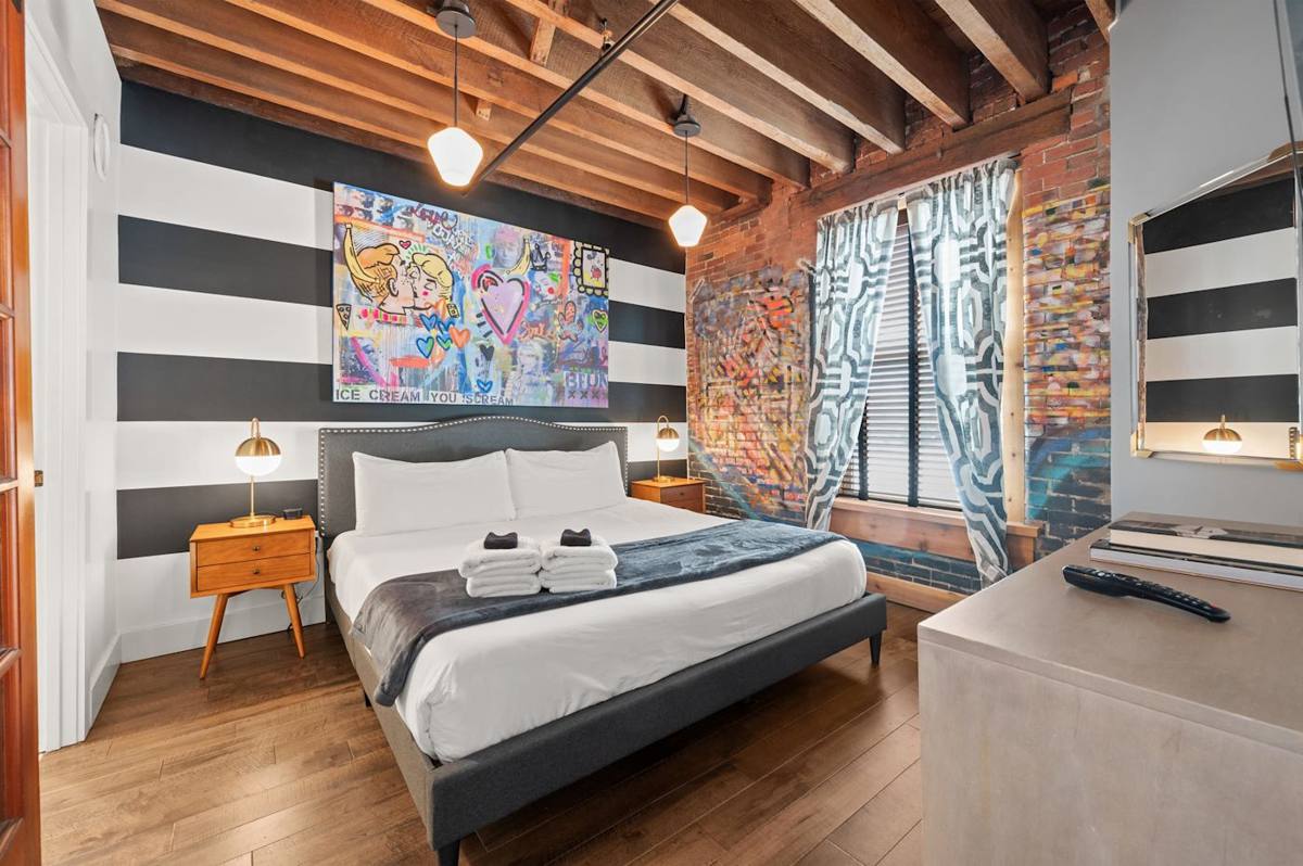 Bedroom Delight: Urban art meets modern comfort in this vibrant Nashville retreat!