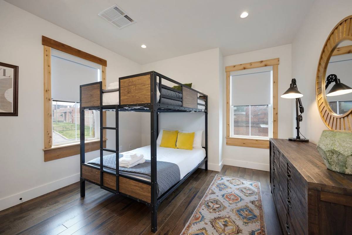 The perfect space-saving solution with a bunk bed and a sleek dresser, creating a functional and fashionable bedroom setup