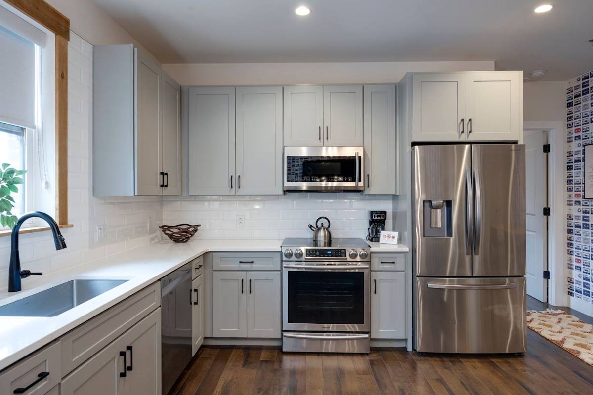 Clean and modern kitchen featuring stainless steel appliances and warm wood floors for a stylish and functional look.