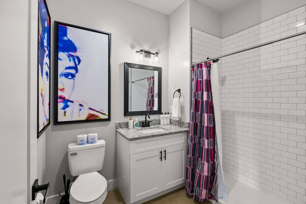 Embrace elegance and functionality in every detail. Upgrade your bathroom with this sophisticated design showcasing a modern toilet, sleek sink, and a luxurious shower, creating a harmonious space for both style and functionality.