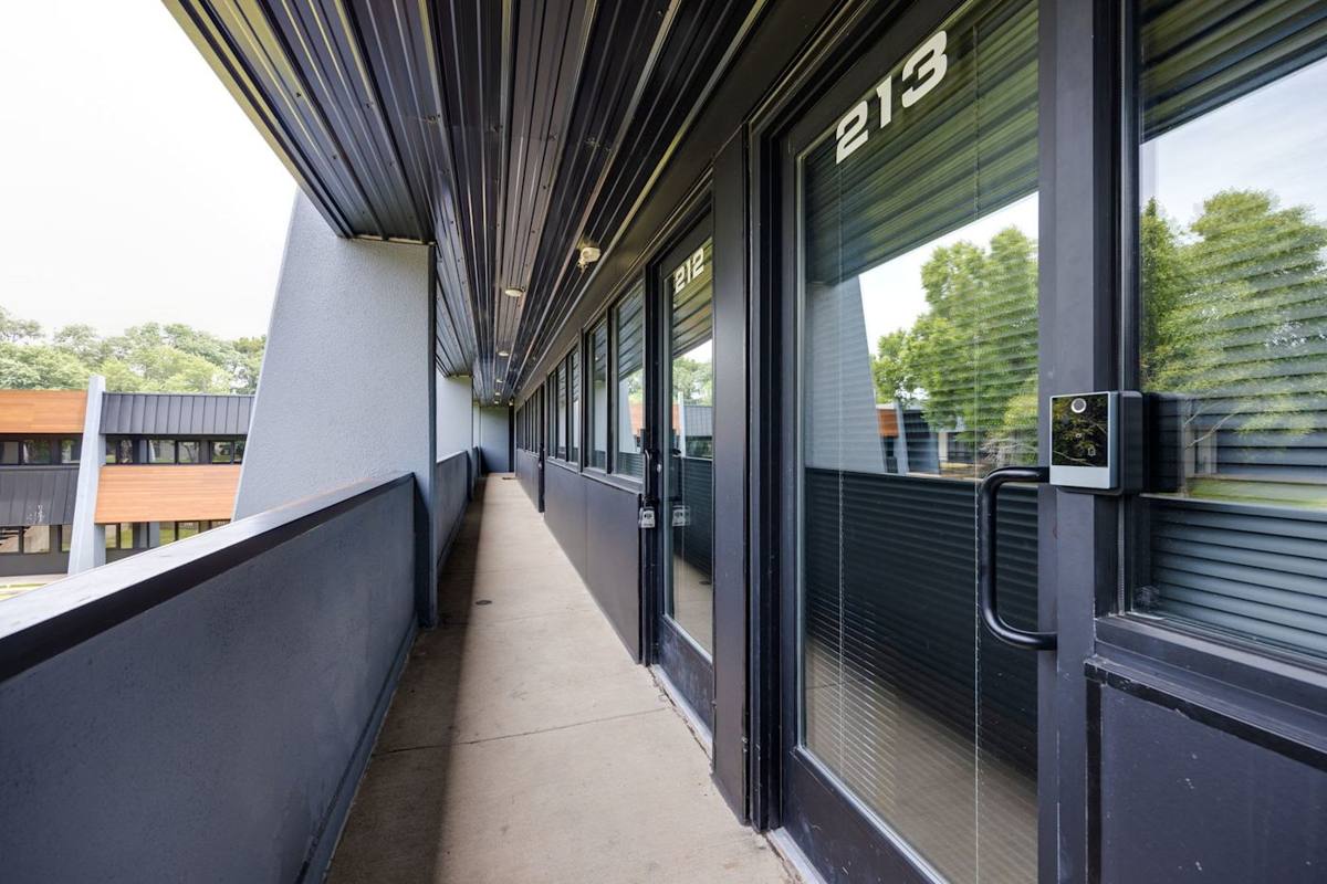 A stylish retreat overlooking the metropolis  Adorned with sophisticated black railings, this apartment balcony offers a breathtaking view of the city skyline while inviting occupants to relax and unwind in a contemporary setting.