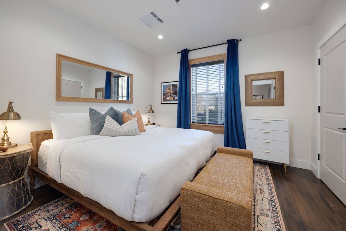 Bedroom Retreat: Bright and airy space featuring a plush king bed, stylish decor, and sunny views!
