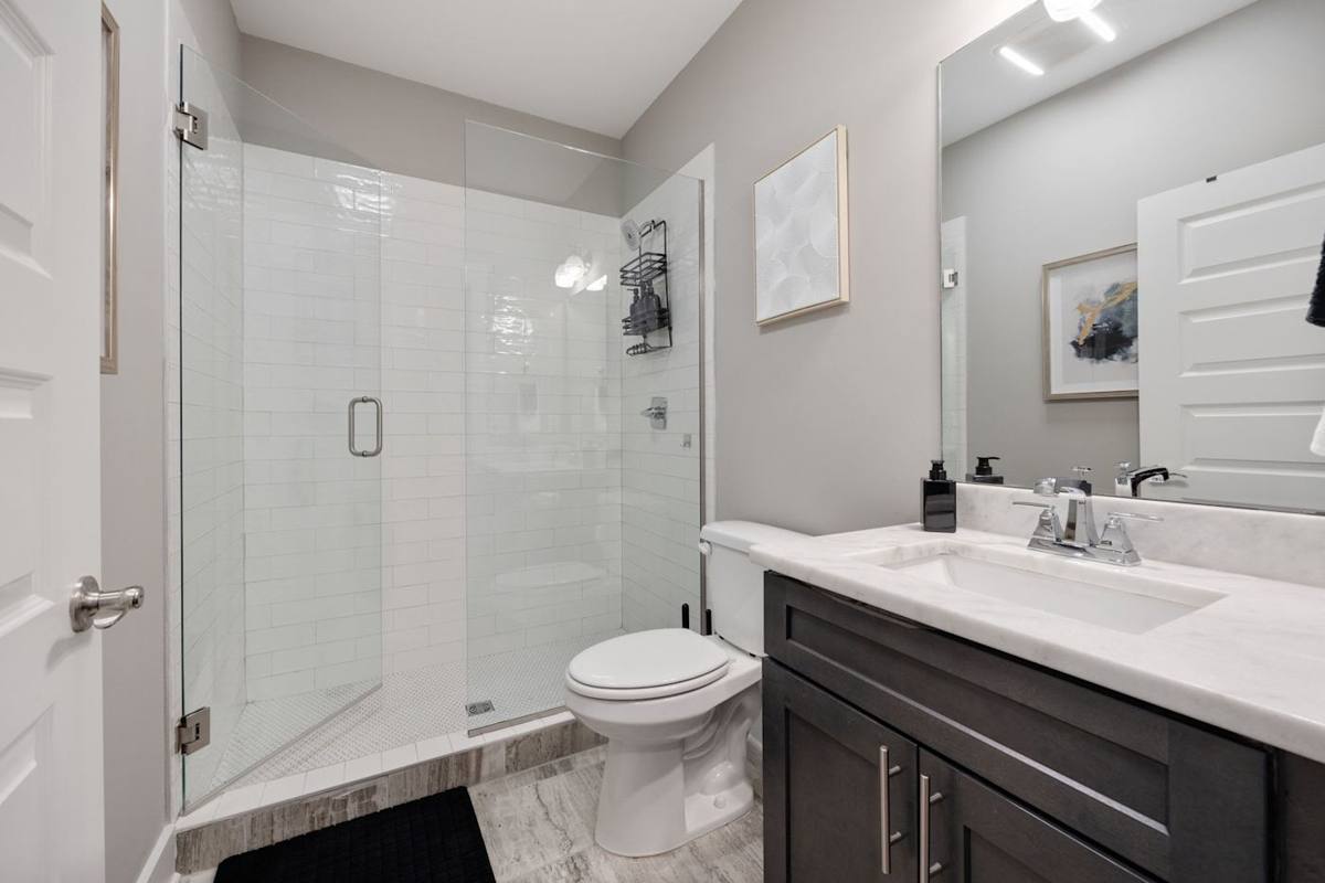 Refresh in a sleek, modern shower with elegant finishes and bright lighting!