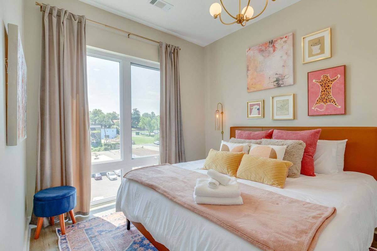 Bright space with modern decor, expansive window views, and plush bedding!