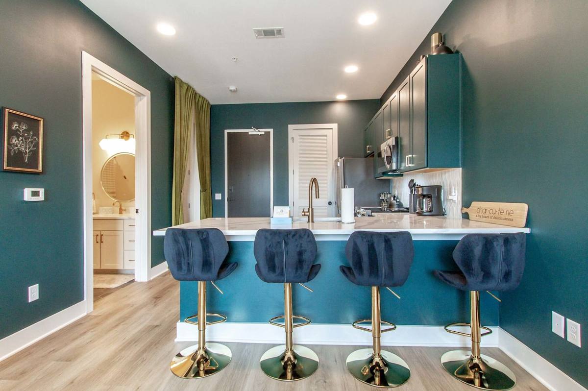 Entertain in style at the stunning bar with gold accents and bold blue walls!