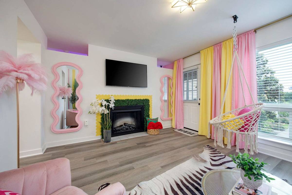 Enjoy vibrant decor, a stylish fireplace, and a playful hanging chair!