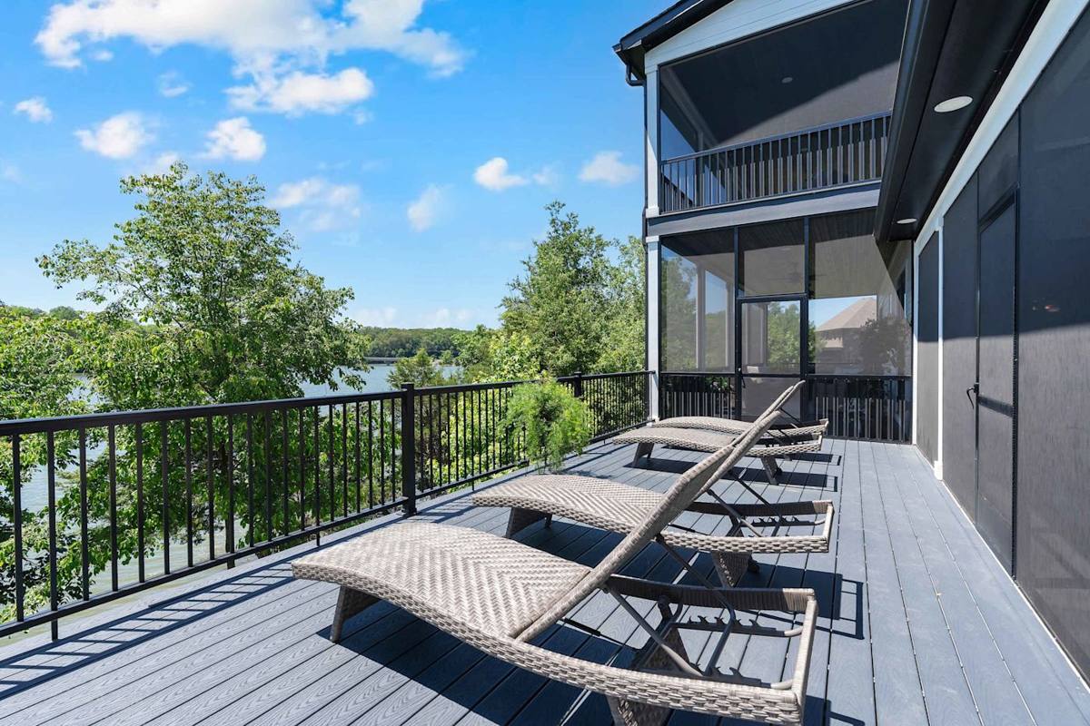 Unwind on the sun-soaked deck with stunning lake views and plush lounge chairs!