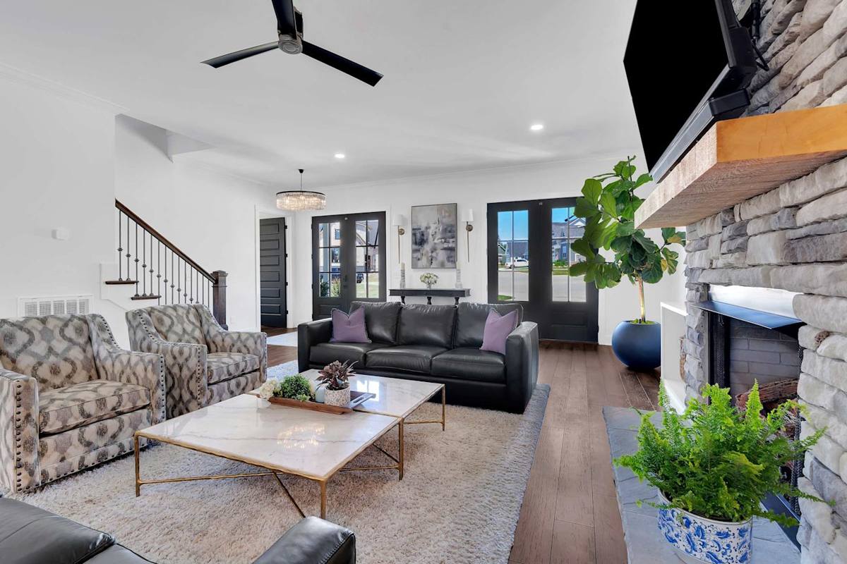 Stylish sanctuary with plush seating, natural light, and a charming fireplace for gatherings!