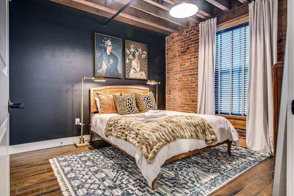 Stylish bedroom with bold decor and warm lighting for a perfect Nashville escape!