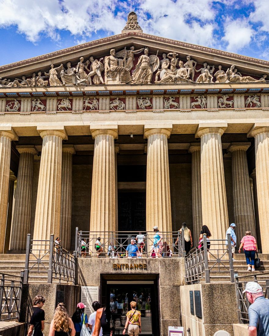 Families walking up the steps of the Parthenon in Centennial Park